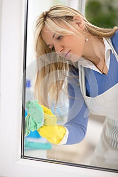 Housemaid cleans window