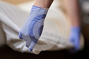 Housemaid doing regular bed linen change in room