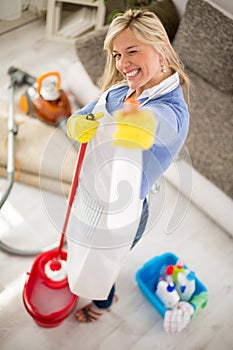 Housemaid with products for cleaning house in hands make joke