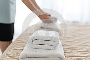 Housemaid woman holding white towels in hands