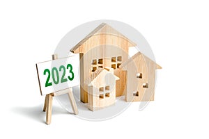 Houses and 2023 sign. Mortgage loan rates. Review real estate market in new year. Forecast new trends and changes in housing