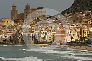 Houses along the shoreline and cathedral in background, Cefalu,