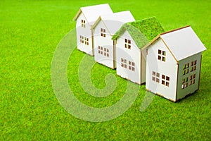 Houses Arranged In Row On Grassy Field