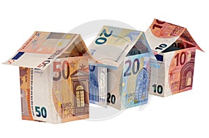 Houses in banknotes on whiet background