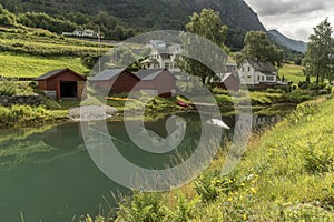 Houses and Boat houses on a stream Olden Norway.