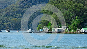 Houses and Boat Sheds amongst the trees on Hawkesbury River on Sydney Central Coast NSW Australia