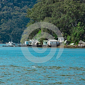 Houses and Boat Sheds amongst the trees on Hawkesbury River on Sydney Central Coast NSW Australia