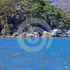 Houses and Boat Sheds amongst the trees on Hawkesbury River on Sydney Central Coast NSW Australia