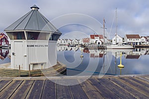 Houses and boats are reflected in the water