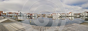 Houses and boats are reflected in the water