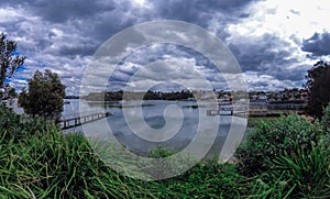 Houses, boats, wharfs, Trees and flowers on Sydney George River mouth at Tom Uglys Bridge NSW Australia.