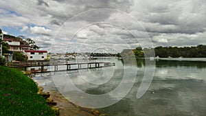 Houses, boats, wharfs, Trees and flowers on Sydney George River mouth at Tom Uglys Bridge NSW Australia.