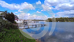 Houses, boats, wharfs, Trees and flowers on Sydney George River mouth at Tom Uglys Bridge NSW Australia.