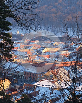 Houses in Brasov city, Romania, during a Winter sunset - view from an elevated position above the city