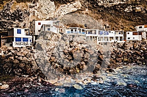 Houses build in the rock face of a cave. Historic old village. White houses on the coast. Village in a cave. Poris de Candelaria,