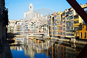 Houses and church on river bank of Onyar from Eiffel bridge in Gerona