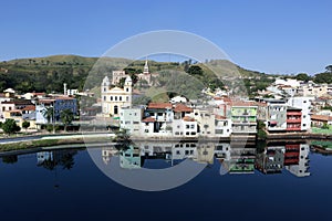 Houses and churches reflected in the blue waters photo