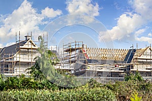 Houses construction with  rafters and scaffoldings on cloudy day