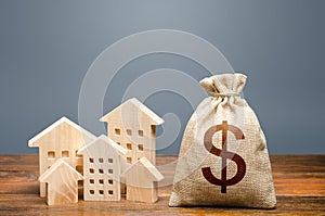 Houses and dollar money bag. Community municipal budget. Investments in real estate and construction industry. Overheated market.