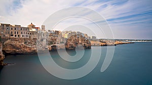 Houses on dramatic cliffs over Adriatic Sea On A Sunny Autumn Day - Long Exposure - Polignano a Mare- Apulia - Italy photo
