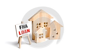 Houses and easel with FHA loan. Mortgage insured by Federal Housing Administration Loan. Affordable loans for borrowers with a low photo