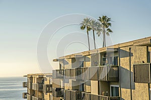 Houses exterior against sea sky and palm trees at Del Mar Southern California