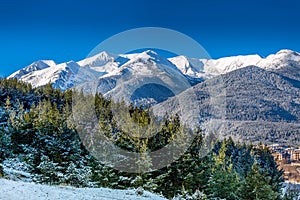 Houses and snow mountains in Bansko, Bulgaria photo