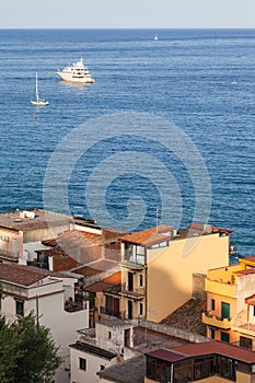 Houses in Giardini Naxos town and ships in Sea