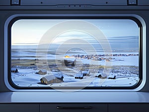 Winter landscape viewed from train window shows snowy prairie with small town at dusk. Houses have icicles on rooftops photo