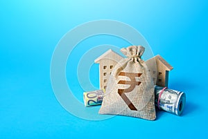 Houses and indian rupee money bag. Asset, financial resource management. Building up capital, saving from inflation risks. Real