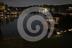 Houses on the lake, with lights during the night, the concept of tranquillity and peace photo