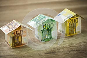 Houses made of euros currency banknotes