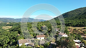 Houses among mountains and green trees. Scenic Aerial landscape of nature. Travel in Italy