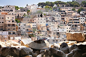 Houses of an old arabian village in Jerusalem, Israel with blurred stones on the foreground