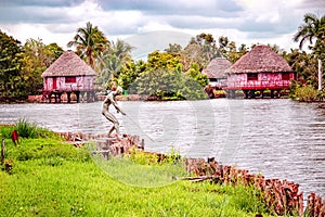 Houses over water in traditional indian village Boca de Guama Nature Reserve, Cuba photo