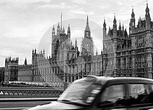 The houses of parliament with taxi passing in front