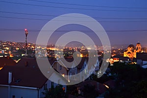 Houses with red roofs with city lights