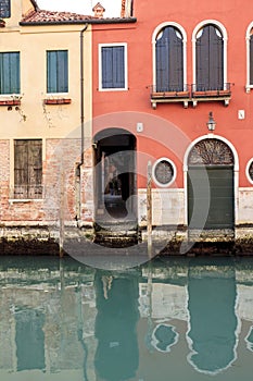 Houses reflecting in the narrow canal in Venice, Italy