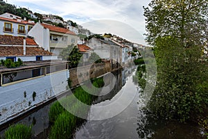 Houses reflecting in a river in the small town Aljezur, Algarve, Portugal