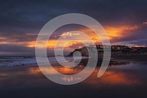 Houses reflection on the Sopelana beach at sunset