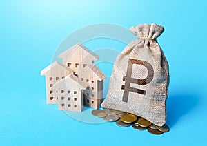 Houses and russian ruble money bag. Increasing property value. Fair market price. Home taxation. Residential or commercial