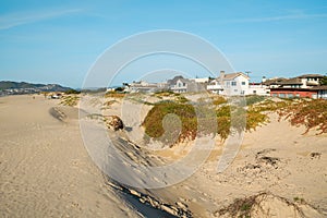 Houses that are set amid coastal sand dunes. Beautiful houses with ocean views in a small beach town, California