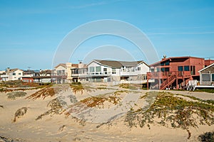 Houses that are set amid coastal sand dunes. Beautiful houses with ocean views in a small beach town, California