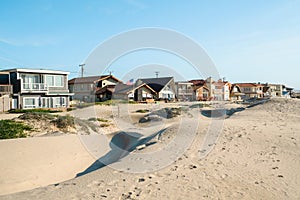 Houses that are set amid coastal sand dunes. Beautiful houses with ocean views in a small beach town, California