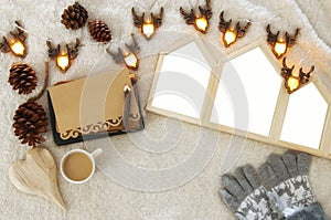 Houses shape wooden photo frames over cozy and warm fur carpet. Top view. For photography montage