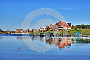 Houses on shore of blue lake