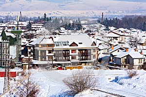 Houses and snow mountains panorama in bulgarian ski resort Bansko