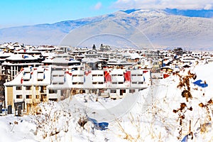 Houses with snow roofs panorama in Bansko, Bulgaria