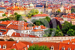 Houses with traditional red roofs in Prague with Charles Bridge, Czech Republic