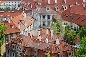 Houses with traditional red roofs and trees in Prague Mala Strana district in the Czech Republic